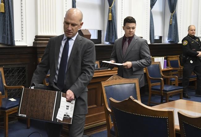 Kyle Rittenhouse arrives in court behind defense attorney Corey Chirafisi before the start of Rittenhouse's trial at the Kenosha County Courthouse in Kenosha, Wis., on Thursday, Nov. 4, 2021. Rittenhouse is accused of killing two people and wounding a third during a protest over police brutality in Kenosha, last year. (Mark Hertzberg /Pool Photo via AP)