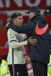 Liverpool's Roberto Firmino embraces Liverpool's manager Jurgen Klopp after being substituted during the English Premier League soccer match between Manchester United and Liverpool at Old Trafford in Manchester, England, Sunday, Oct. 24, 2021. (AP Photo/Rui Vieira)