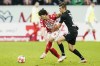Mainz's Jae-Sung Lee, left, and Gladbach's Florian Neuhaus fight for the ball during the Bundesliga soccer match between Mainz and Borussia Moenchengladbach at Mewa Arena in Mainz, Germany, Friday, Nov. 5, 2021. (Uwe Anspach/dpa via AP)