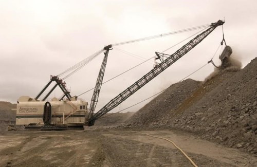 FILE - A coal shovel works at the Midway mine Tuesday, April 14, 2009, in Centertown, Ky. A group of former coal company officials will go on trial in Kentucky next week for allegedly skirting federal rules meant to reduce deadly dust in underground mines. The four men on trial, who worked for now-bankrupt Armstrong Coal, ordered workers at two Kentucky mines to rig dust-monitoring equipment to pass air quality tests, federal prosecutors said. (AP Photo/ Daniel R. Patmore)