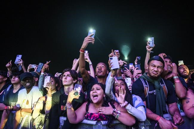 The crowd watches as Travis Scott performs at Astroworld Festival at NRG park on Friday, Nov. 5, 2021. Several people died and numerous others were injured in what officials described as a surge of the crowd at the music festival while Scott was performing. Officials declared a “mass casualty incident” just after 9 p.m. Friday during the festival where an estimated 50,000 people were in attendance, Houston Fire Chief Samuel Peña told reporters at a news conference. (Jamaal Ellis/Houston Chronicle via AP)