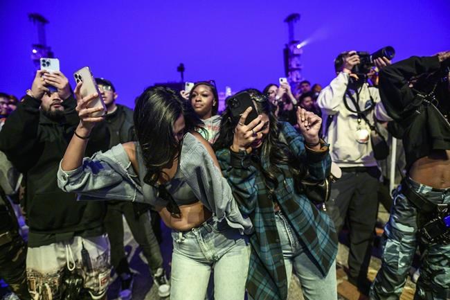 The crowd watches as Travis Scott performs at Astroworld Festival at NRG park on Friday, Nov. 5, 2021. Several people died and numerous others were injured in what officials described as a surge of the crowd at the music festival while Scott was performing. Officials declared a “mass casualty incident” just after 9 p.m. Friday during the festival where an estimated 50,000 people were in attendance, Houston Fire Chief Samuel Peña told reporters at a news conference. (Jamaal Ellis/Houston Chronicle via AP)