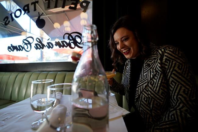Erin Tridle holds a video chat with her boyfriend Jordan Commarrieu living in Paris from their favorite French restaurant