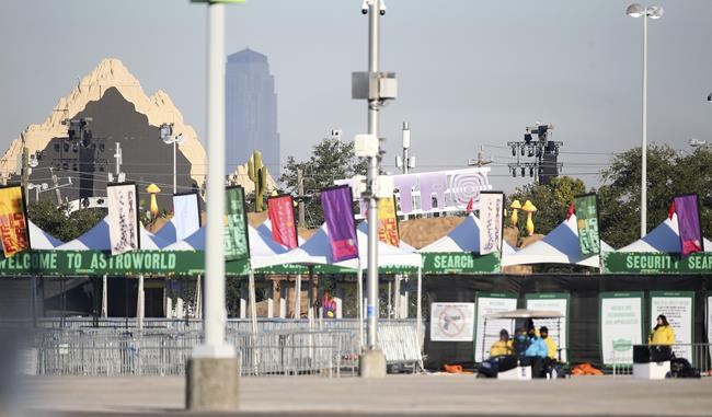 Security walks around the NRG lots where Astroworld was held the night before in Houston on Saturday, Nov. 6, 2021. Several people died and numerous others were injured in what officials described as a surge of the crowd at the music festival while Travis Scott was performing Friday night. (Elizabeth Conley/Houston Chronicle via AP)