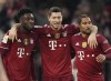 Bayern's Robert Lewandowski, center, celebrates his side's second goal with Bayern's Alphonso Davies, left, and Serge Gnabry during the German Bundesliga soccer match between FC Bayern Munich and SC Freiburg in Munich, Germany, Saturday, Nov. 6, 2021. (AP Photo/Matthias Schrader)