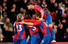 Crystal Palace's Wilfried Zaha celebrates scoring with teammates during the English Premier League soccer match between Crystal Palace and Wolverhampton Wanderers at Selhurst Park, London, Saturday Nov. 6, 2021. (Aaron Chown/PA via AP)