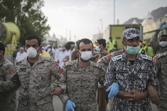 FILE - Saudi security forces cordon the site where pilgrims were crushed and trampled to death during the annual hajj pilgrimage in Mina, Saudi Arabia, Thursday, Sept. 24, 2015. The crowd deaths at a Houston music festival on Friday, Nov. 5, 2021, have added to the long list of people who have been crushed at a major event. Such tragedies have been occurring around the world for a long time at concerts, sports events and religious gatherings. (AP Photo/Mosa'ab Elshamy, File)