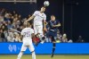 Real Salt Lake midfielder Damir Kreilach, center top, heads the ball away from Sporting Kansas City midfielder Remi Walter, right, during the first half of an MLS soccer match Sunday, Nov. 7, 2021, in Kansas City, Kan. (AP Photo/Nick Tre. Smith)