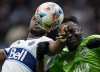 Vancouver Whitecaps' Cristian Dajome, left, and Seattle Sounders' Yeimar Gomez Andrade vie for the ball during the first half of an MLS soccer game in Vancouver, B.C., Sunday, Nov. 7, 2021. THE CANADIAN PRESS/Darryl Dyck