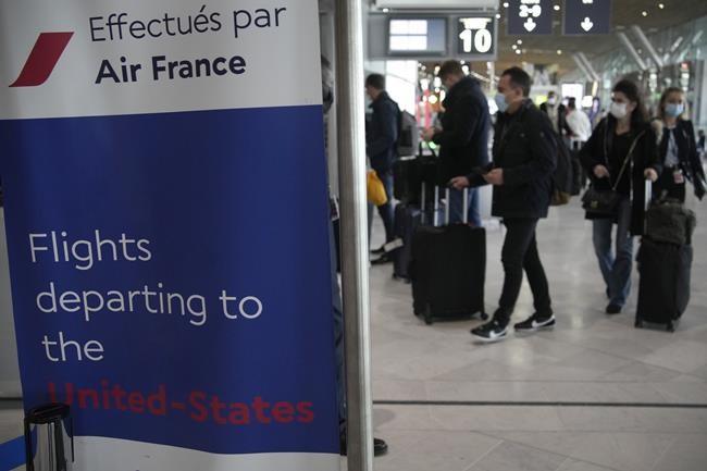 Travelers for the United States arrive at Air France desk at the Charles de Gaulle airport, north of Paris, Monday, Nov.8, 2021. The U.S. lifted restrictions Monday on travel from a long list of countries including Mexico, Canada and most of Europe, allowing tourists to make long-delayed trips and family members to reconnect with loved ones after more than a year and a half apart because of the pandemic. (AP Photo/Christophe Ena)
