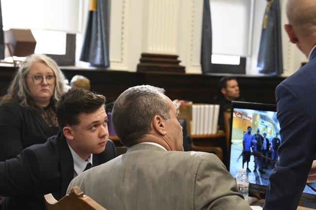Kyle Rittenhouse listens to defense attorneys Mark Richards and Corey Chirafisi during Rittenhouse's trial at the Kenosha County Courthouse in Kenosha, Wis., on Friday, Nov. 5, 2021. Rittenhouse is accused of killing two people and wounding a third during a protest over police brutality in Kenosha, last year. (Mark Hertzberg /Pool Photo via AP)