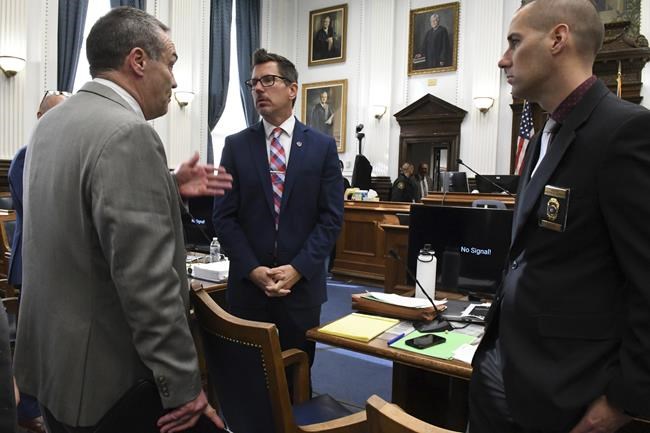Defense attorney Mark Richards speaks with Assistant District Attorney Thomas Biner and Kenosha Police detective Martin Howard after a morning break in Kyle Rittenhouse's trial at the Kenosha County Courthouse in Kenosha, Wis., on Friday, Nov. 5, 2021. Rittenhouse is accused of killing two people and wounding a third during a protest over police brutality in Kenosha, last year. (Mark Hertzberg /Pool Photo via AP)