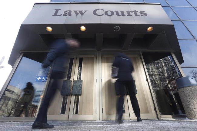 People enter the Law Courts in Winnipeg on Monday, Feb. 5, 2018. A group of First Nations in Manitoba is in court asking for a judicial review related to ongoing work on a multimillion-dollar flood protection project. THE CANADIAN PRESS/John Woods