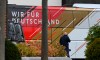 The team bus of Germany's national soccer team is parked in front of the team hotel in Wolfsburg, Germany, prior the World Cup qualifying match against Liechtenstein, Tuesday, Nov. 9, 2021. There is said to be a positive Corona case in the circle of the national soccer team. National coach Hansi Flick cancelled the planned training in the morning at the stadium in Wolfsburg. Five players have to be quarantined in Wolfsburg. (Swen Pfoertner/dpa via AP)