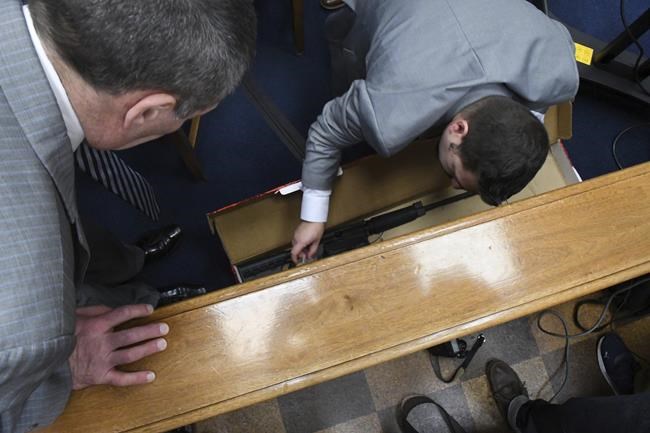 Mark Richards, Kyle Rittenhouse's lead attorney, left, and Kenosha Police Department Detective Ben Antaramian, center, look at the weapon Rittenhouse used on the night of Aug. 25, 2020, during the trial at the Kenosha County Courthouse in Kenosha, Wis., on Tuesday, Nov. 9, 2021. Rittenhouse is accused of killing two people and wounding a third during a protest over police brutality in Kenosha, last year. (Mark Hertzberg /Pool Photo via AP)