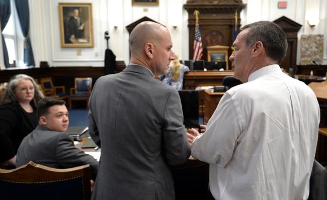 Mark Richards, right, and Corey Chirafisi, second from right, both attorneys for Kyle Rittenhouse, talk as Rittenhouse, second from left, and Natalie Wisco, another of his attorneys, look on before the start of the day at the Kenosha County Courthouse in Kenosha, Wis., on Tuesday, Nov. 9, 2021. Rittenhouse is accused of killing two people and wounding a third during a protest over police brutality in Kenosha, last year. (Sean Krajacic/The Kenosha News via AP, Pool)