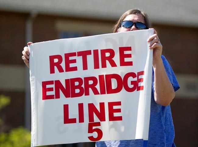 FILE - In this July 6, 2017, file photo, Lauren Sargent, takes part in a protest before the Enbridge Line 5 pipeline public information session in Holt, Mich. THE CANADIAN PRESS/The Grand Rapids Press-Cory Morse