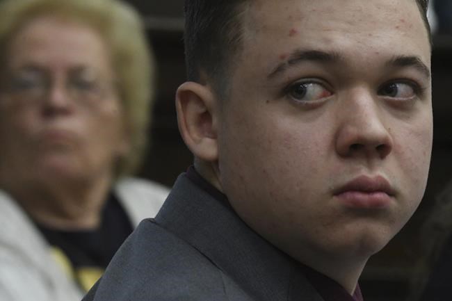 Kyle Rittenhouse looks to the gallery as Dr. Doug Kelley, a forensic pathologist with the Milwaukee County testifies about the autopsy he performed on Anthony Huber, during Rittenhouse's trial at the Kenosha County Courthouse in Kenosha, Wis., on Tuesday, Nov. 9, 2021. Rittenhouse is accused of killing two people and wounding a third during a protest over police brutality in Kenosha, last year. (Mark Hertzberg /Pool Photo via AP)