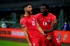 Canada's Jonathan Osorio, left, celebrates scoring his side's first goal against Mexico during a qualifying soccer match for the FIFA World Cup Qatar 2022, at Azteca stadium in Mexico City, Thursday, Oct. 7, 2021. THE CANADIAN PRESS/AP, Fernando Llano