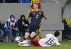 Sweden's Emil Krafth, left, challenges for the ball with Georgia's Irakli Azarovi during the World Cup 2022 group B qualifying soccer match between Georgia and Sweden in Batumi, Georgia, Thursday, Nov. 11, 2021. (AP Photo/Shakh Aivazov)