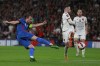 England's Harry Kane takes a shot at goal past Albania's Lorenc Trashi during the World Cup 2022 group I qualifying soccer match between England and Albania at Wembley stadium in London, Friday, Nov. 12, 2021. (AP Photo/Ian Walton)