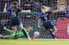 OL Reign's Eugenie Le Sommer (9) scores against Washington Spirit goalie Aubrey Bledsoe as Rose Lavelle looks on in the first half in the semifinals of the UWSL soccer playoffs Sunday, Nov. 14, 2021, in Tacoma, Wash. (AP Photo/Elaine Thompson)