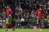 Portugal's Cristiano Ronaldo, left, and Portugal's Joao Felix react after Serbia's Aleksandar Mitrovic scoring his side's second goal during the World Cup 2022 group A qualifying soccer match between Portugal and Serbia at the Luz stadium in Lisbon, Sunday, Nov 14, 2021. (AP Photo/Armando Franca)