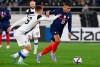 Finland's Leo Vaisanen, left, fights for the ball with France's Kylian Mbappe during the World Cup 2022 group D qualifying soccer match between Finland and France at the Helsinki Olympic Stadium in Helsinki, Finland, Tuesday, Nov. 16, 2021. (Markku Ulander/Lehtikuva via AP)