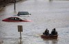 People who were stranded by high water due to flooding are rescued by a volunteer operating a boat in Abbotsford, B.C., on Tuesday, November 16, 2021. THE CANADIAN PRESS/Darryl Dyck