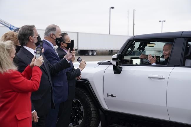 President Joe Biden stops to talk to people as he test drives a Hummer at the General Motors Factory ZERO electric vehicle assembly plant during a tour Wednesday, Nov. 17, 2021, in Detroit. (AP Photo/Evan Vucci)
