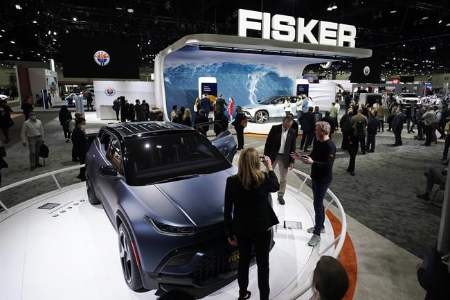 Henrik Fisker, Chairman & CEO at Fisker Inc. at right, shows his company's new EV, the Ocean, at the AutoMobility LA Auto Show Wednesday, Nov. 17, 2021, in Los Angeles. (AP Photo/Marcio Jose Sanchez)