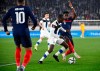 Finland's Glen Kamara, center, fights for the ball with France's Aurelien Tchouameni during the World Cup 2022 group D qualifying soccer match between Finland and France at the Helsinki Olympic Stadium in Helsinki, Finland, Tuesday, Nov. 16, 2021. (Markku Ulander/Lehtikuva via AP)