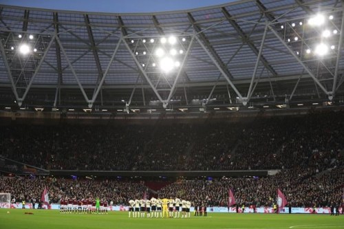 Players gather to pay their tribute to Remembrance Sunday prior to the British Premier League soccer match between West Ham United and Liverpool at the London stadium in London, England, Sunday, Nov. 7, 2021. (AP Photo/Ian Walton)