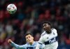 Vancouver Whitecaps' Janio Bikel, right, gets his head on the ball in front of Sporting Kansas City's Daniel Salloi during second half MLS soccer action in Vancouver, B.C., Sunday, Oct. 17, 2021. The 'Caps (12-9-13) are set to make their first post-season appearance in four years Saturday when they visit Sporting Kansas City (17-10-7).&nbsp;THE CANADIAN PRESS/Darryl Dyck