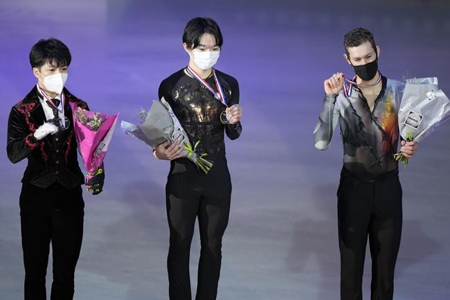 Yuma Kagiyama of Japan, with gold medal, center, Shun Sato of Japan, left, with silver medal, and Jason Brown of US with bronze medal pose during the trophy ceremony in the Men Skating during the ISU figure skating France's Trophy, in Grenoble, French Alps, France, Saturday, Nov. 20, 2021. (AP Photo/Francois Mori)
