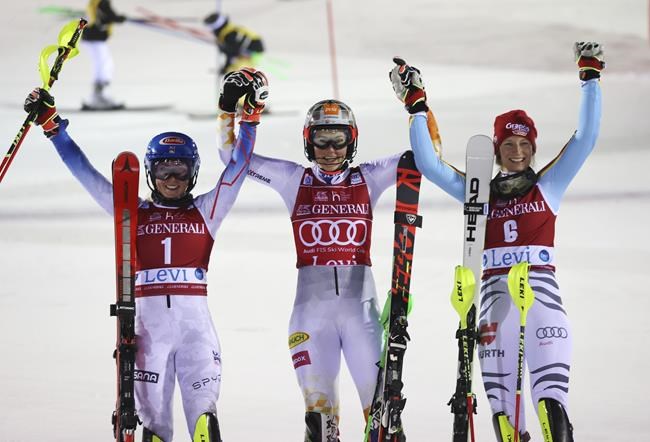 Slovakia's Petra Vlhova, center, winner of an alpine ski, World Cup women's slalom, celebrates with second placed United States' Mikaela Shiffrin, left, and third placed Germany's Lena Duerr, in Levi, Finland, Sunday, Nov. 21, 2021. (AP Photo/Alessandro Trovati)