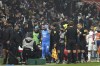 Marseille's Dimitri Payet, center, is surrounded by his staff as he leaves the field after being injured by an object thrown by a Lyon's supporter during the French League One soccer match between Lyon and Marseille, in Decines, near Lyon, central France, Sunday, Nov. 21, 2021. (AP Photo/Laurent Cipriani)
