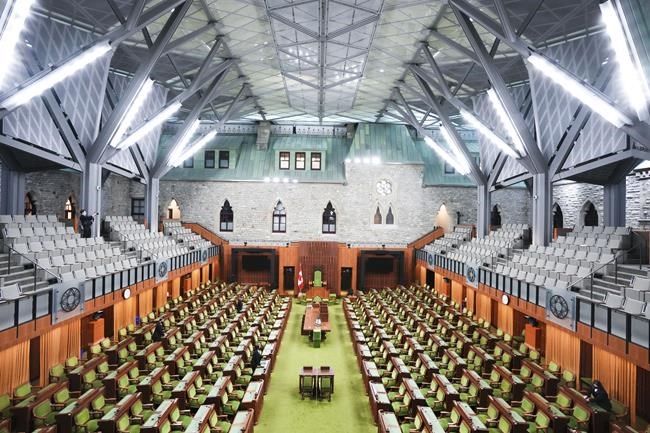 Pages makes preparations in The House of Commons on Parliament Hill in Ottawa, Friday, Nov. 19, 2021. THE CANADIAN PRESS/Sean Kilpatrick