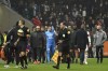 Marseille's Dimitri Payet, center, is surrounded by his staff as he leaves the field after being injured by an object thrown by a Lyon's supporter during the French League One soccer match between Lyon and Marseille, in Decines, near Lyon, central France, Sunday, Nov. 21, 2021. (AP Photo/Laurent Cipriani)