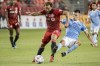 Toronto FC midfielder Nick DeLeon (18) is tackled by New York City midfielder Valentin Castellanos (11) during second half MLS soccer action in Toronto on Saturday August 7, 2021. THE CANADIAN PRESS/Chris Katsarov