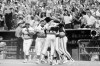 FILE - Astros pinch runner Rafael Landestoy is greeted by teammates after he scored the winning run during the 11th inning in Game 3 of the National League playoffs against the Philadelphia Phillies in Houston. Houston won 1-0. Manager Bill Virdon is at left of Landestoy. Virdon, the steady centerfielder who won the 1955 National League Rookie of the Year for St. Louis as a player and then guided the Houston Astros to three straight playoff appearances as a manager, has died. He was 90. Both the Cardinals and Pirates confirmed Virdon's passing on Tuesday, Nov. 23, 2021. AP Photo/Brian Horton, File)