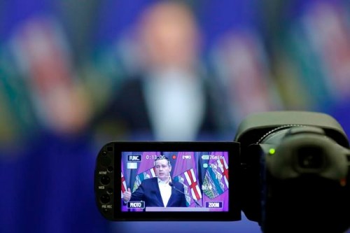 In a camera monitor, Alberta Premier Jason Kenney speaks after the United Conservative Party annual meeting in Calgary, Sunday, Nov. 21, 2021. A coalition of at least eight environmental groups are threatening to sue Kenney for defamation if he doesn't retract and apologize for statements saying a public inquiry found they spread misinformation about the province's oil and gas industry. THE CANADIAN PRESS/Larry MacDougal