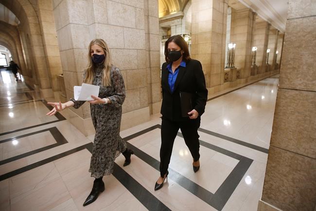 Manitoba Premier Heather Stefanson, right, walks to her office with her assistant Olivia Billson after speaking to media before the reading of the Speech from the Throne at the Manitoba Legislature in Winnipeg, Tuesday, Nov. 23, 2021. THE CANADIAN PRESS/John Woods