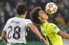 Dortmund's Axel Witsel, right, and Sporting's Pedro Goncalves compete for the ball during a Champions League Group C soccer match between Sporting CP and Borussia Dortmund at the Alvalade stadium in Lisbon, Portugal, Wednesday, Nov. 24, 2021. (AP Photo/Armando Franca)