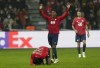 Lille's Timothy Weah is on the ground in front of Lille's Jonathan David during the Champions League group G soccer match between OSC Lille and RB Salzburg at the Stade Pierre Mauroy - Villeneuve d'Ascq in Lille, France, Tuesday, Nov. 23, 2021. (AP Photo/Michel Spingler)
