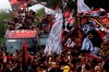 Fans of Brazil's soccer team Flamengo accompany the bus transporting the team to out of town matches, in Rio de Janeiro, Brazil, Friday, Nov. 19, 2021. The team is traveling to Porto Alegre to play a Brazilian Championship game on Saturday and then continue on to Montevideo for the Copa Libertadores final soccer game against Palmeiras on Nov. 27. (AP Photo/Bruna Prado)