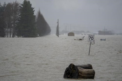 Debris is seen along a flooded road in Abbotsford, B.C., Thursday, Nov. 25, 2021. THE CANADIAN PRESS/Jonathan Hayward