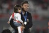 River Plate coach Marcelo Gallardo holds his sone Benjamin as he celebrates winning the local soccer tournament at the Monumental in Buenos Aires, Argentina Thursday, Nov. 25, 2021. River defeated Racing 4-0 and became the tournament champions. (AP Photo/Gustavo Garello)