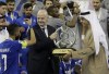 FIFA President Gianni Infantino, center, prepares to present the trophy to Saudi Arabia's Al Hilal midfielder Salman Al-Faraj, left, after winning the AFC Champions League final soccer match against South Korea's Pohang Steelers 2-0, at the King Fahd International Stadium in Riyadh, Saudi Arabia, Tuesday, Nov. 23, 2021. (AP Photo/Amr Nabil)