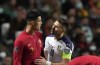 Portugal's Cristiano Ronaldo, left, discusses with Serbia's Dusan Tadic during the World Cup 2022 group A qualifying soccer match between Portugal and Serbia at the Luz stadium in Lisbon, Sunday, Nov 14, 2021. (AP Photo/Armando Franca)